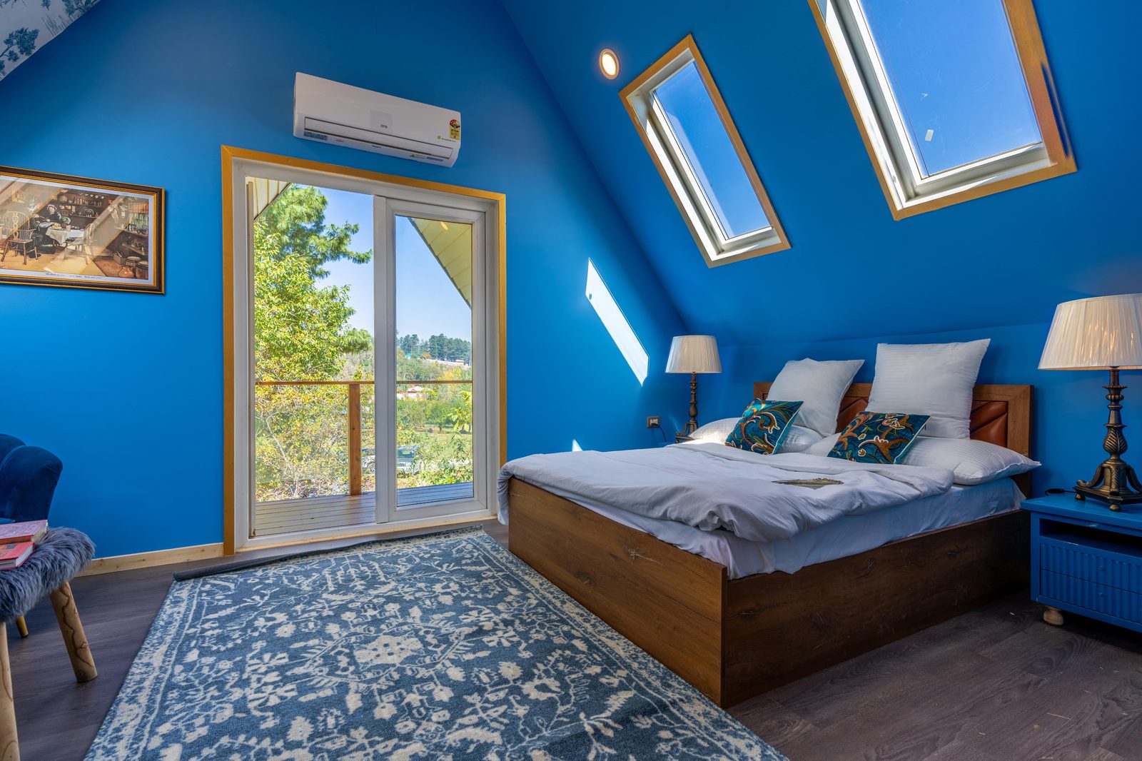 Bright attic bedroom with two roof windows after an L-shaped dormer conversion